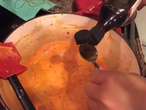 Adding the fish sauce to the red curry gluten free - Paleo Coconut Curry with Red Chillies