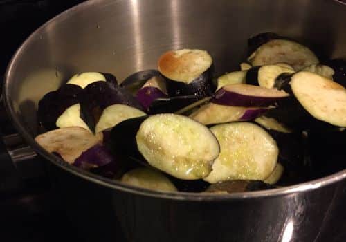 add_sliced_japanese_eggplant_to_a_pot_adding_garlic_fish_sauce_olive_oil_tomato_paste