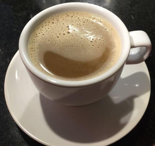 Photo of cup with frothy coffee blocks coffee. Coffee Blocks offers packets of instant high quality, no additives black coffee and coconut oil. A great option for those looking for whole foods bulletproof coffee packets. You can find Coffee Blocks on Amazon as well as via their company website. 