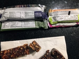 Photo of the back of Freedom Bars and Larabars - to help you compare what makes a Larabar organic vs a Freedom Bar organic. 